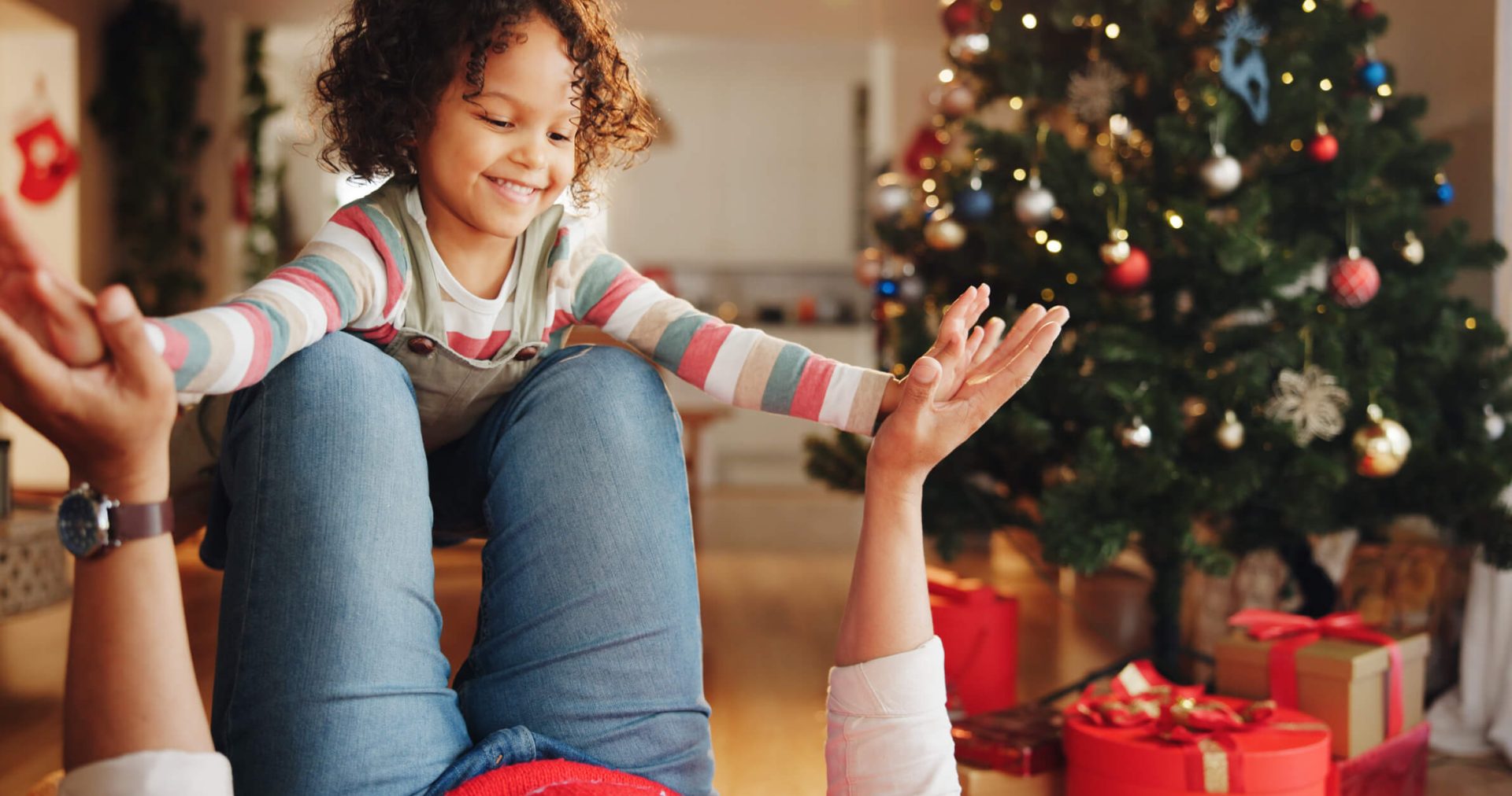 Christmas, airplane and smile with child and parent for festive magic, Noel cheer and xmas celebration. Support, winter holiday and love with people at family home for present, vacation and playful.